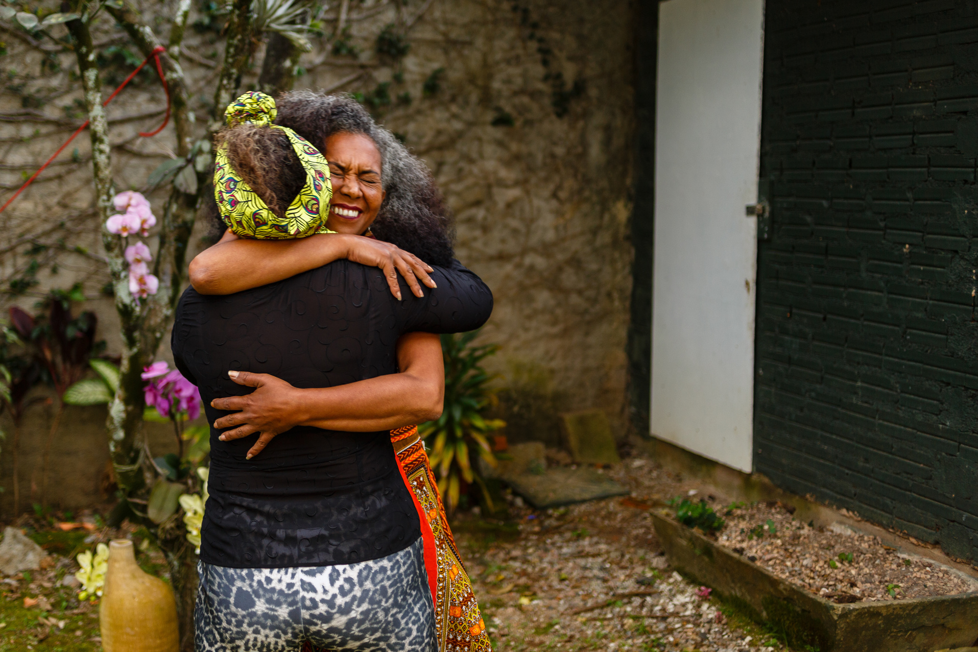 Middle aged black women hugging each other